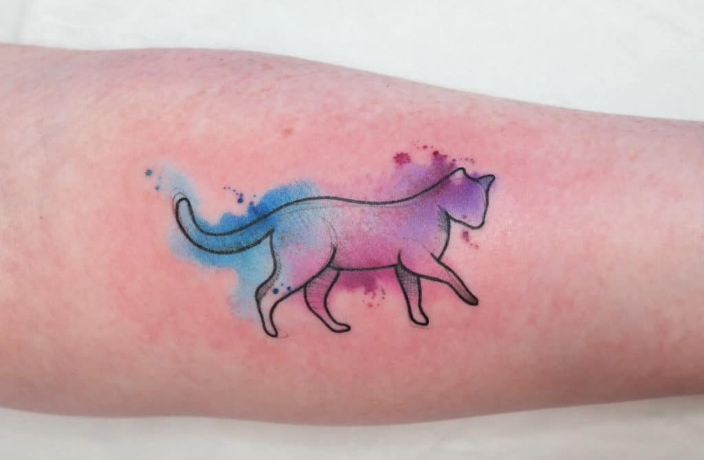 Outline of a cat on a watercolor effect, on a forearm
